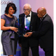 Journalist Simeon Booker (center) is presented with a Phoenix Award at the Congressional Black Caucus Foundation’s annual Legislative Conference Phoenix Awards Dinner in Washington, D.C., on Sept. 18, 2010. (Ann Heisenfelt/AP Images)